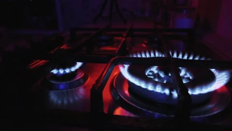 Blue Gas Flames Burning on a Kitchen Stove with Red Lighting Stock-Footage 329683054