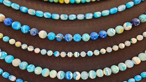 Blue Gemstone Beads on Black Background Stock Photos
