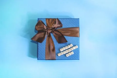 A blue gift on the blue background. Stock Photos