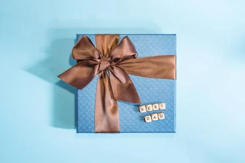 A blue gift on the blue background. Stock Photos