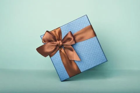 A blue gift on the blue background. Stock Photos