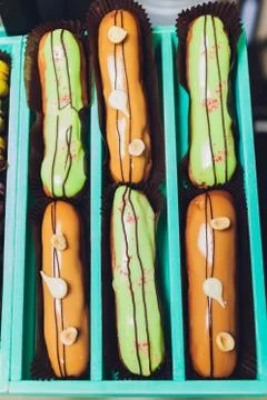 Blue gift box with eclairs and macaroon. Fotos de archivo