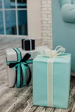 Blue gift boxes, sofa, window and brick wall Stock-Fotos