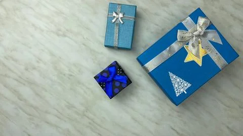 Blue gift boxes on white table Stock Photos
