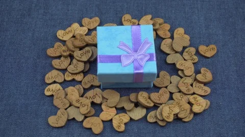 Blue gift in decorative hearts Stock Footage 102883530