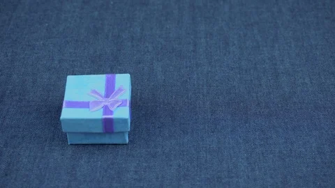 Blue gift on a jeans background Stock Footage 102882910