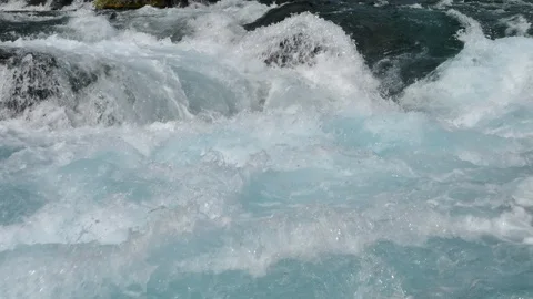Blue glacial river rapids over rocks slow motion Iceland sunny day 4k Stock Footage 108330968