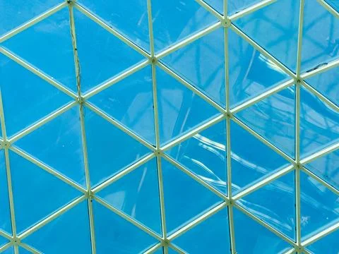 Blue glass ceiling with geometric pattern in a modern building during daytime Stock Photos