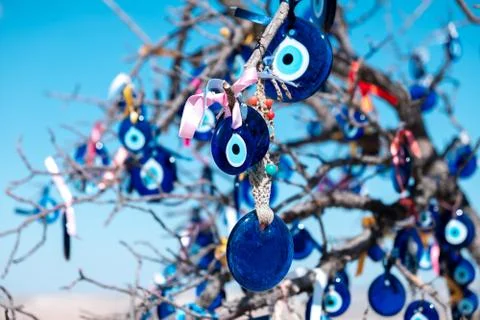 Blue glass evil eyes sign on wish tree in Turkey Stock Photos
