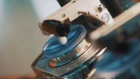 Blue glass lenses fixed in percise measuring machine Stock Footage 76568206