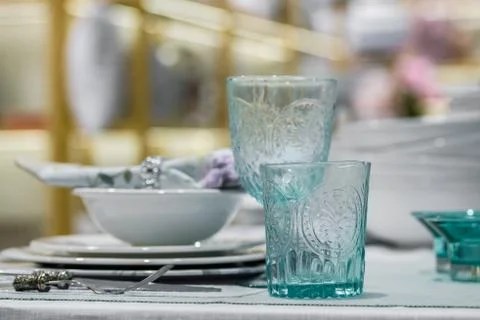 Blue glasses and plates on table Stock Photos
