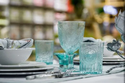 Blue glasses and plates on table Stock Photos
