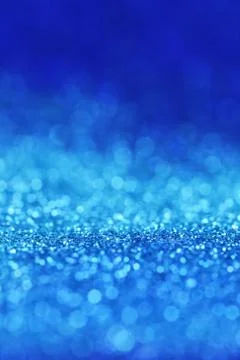Blue glitter background with light blue shining bokeh.panton 2020 Stock Photos