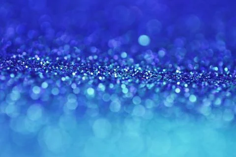 Blue glitter background with light blue shining bokeh. Stock Photos