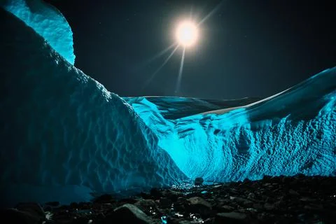 The Blue Glow Inside a Hidden Ice Cave. Antarctica. Queen mount land Stock Photos
