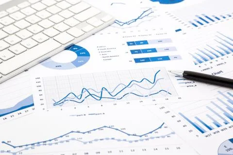 Blue graph and chart reports on office table Stock Photos