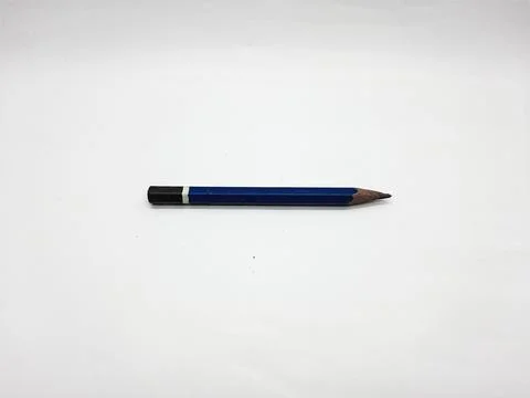 Blue graphite pencil resting on a clean white surface in a studio shot Stock Photos