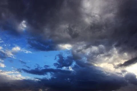 Blue-gray sky with different clouds Stock Photos