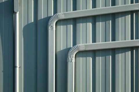 Blue gray wall and down spouts Stock Photos