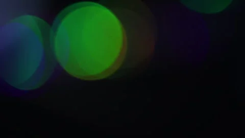 Blue-green light with large lights on the left in the blackness Stockbeeldmateriaal 309488212