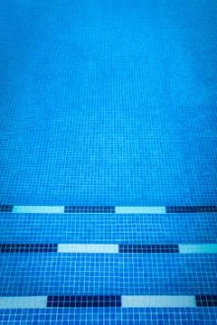 Blue gresite pool bottom. Summer, water sports and relax concept. Stock Photos
