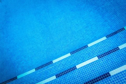 Blue gresite pool bottom. Summer, water sports and relax concept. Stock Photos