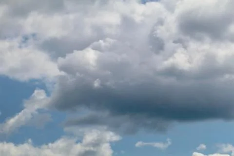 Blue grey altocumulus cloudscape with puffy clouds Stock Photos