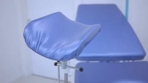 Blue gynecological chair in the women's health clinic. Close-up of an Stock Footage