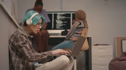 Blue Haired Asian Programmer Working on Laptop in Office Stock Footage 241274393