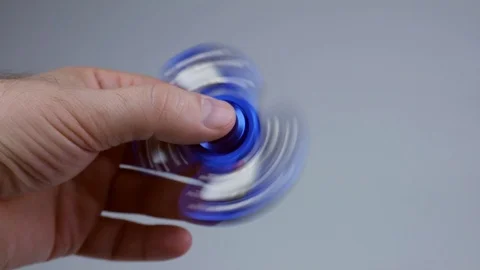 Blue hand spinner, rotating in man's hand. Stock Footage 88996669