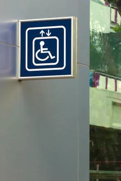 Blue handicap elevator sign, right and below copy space. Stock Photos