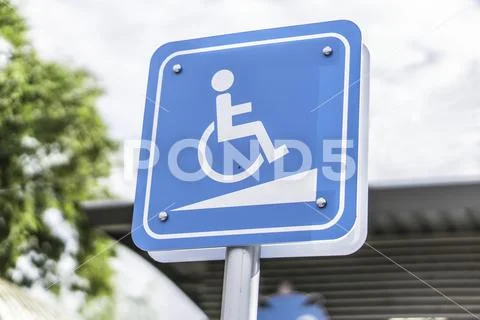 Blue Handicap at parking car sign outdoors for Disabled. Stock Photos