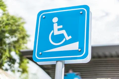 Blue Handicap at parking car sign outdoors for Disabled. Stock Photos