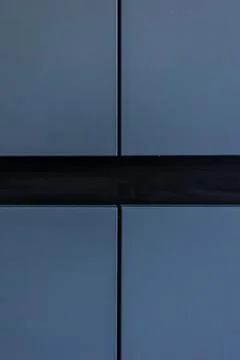 Blue handleless cabinet fronts in vertical crop. Modern kitchen detail. Stock Photos
