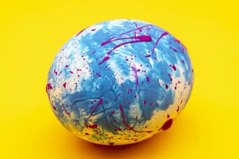Blue handmade Easter egg on a yellow background. Religious traditional hol... Stock Photos