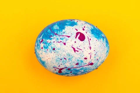 Blue handmade Easter egg on a yellow background. Religious traditional hol... Stock Photos