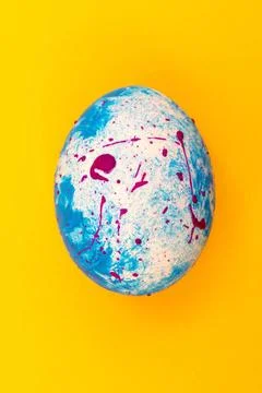 Blue handmade Easter egg on a yellow background. Religious traditional hol... Stock Photos