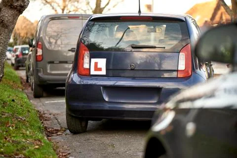 Blue Hatchback Car with Learner Driver Sign Parking at the Side of the Road Stock Photos