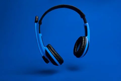 Blue headset on blue background Fotos de archivo