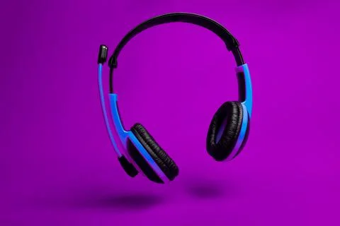 Blue headset on violet background Fotos de archivo