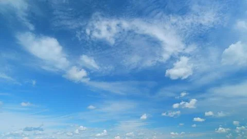 Blue heaven summer cloudscape. Rolling puffy white layered clouds are moving Photos