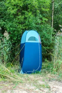 Blue high tent without bottom, camp toilet or changing room, Camping shower Stock Photos