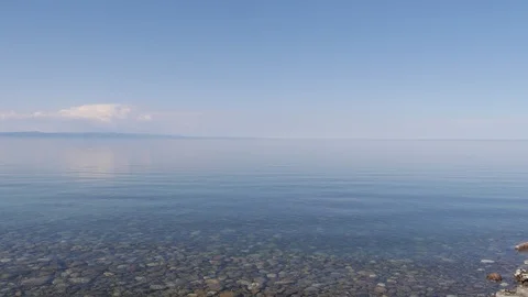 Blue horizon and white clouds of a clear lake Vídeos de archivo 103456954