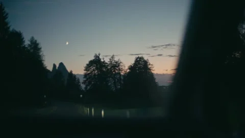 Blue Hour Driving Scene Through Mountain Forests Under a Crescent Moon 库存影片 331164265