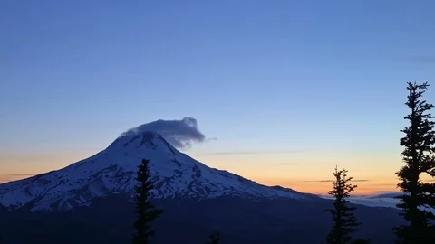 Blue hour dusk summit of Mt. Hood and blowing snow snowcapped snowy peak and Stock-Footage 81597251