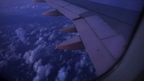 Blue Hour Flight peeping out of airplane window Stock Footage 292946921