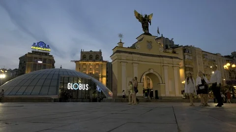 Blue hour low level slider shot past Lyadsky gate and Globus mall in Kiev Stock Footage 93123242