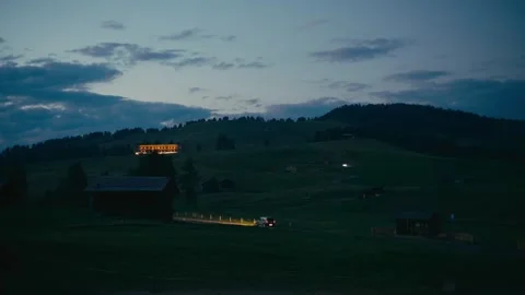 Blue Hour over the Alpine Valley with a Car Driving on the Mountain Road 库存影片 331164221