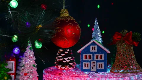 A blue house with a bell and a pine cone near a red ball Stock Footage 322049103