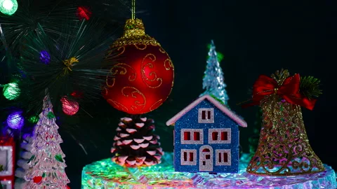 A blue house with a bell and a pine cone near a red ball Stock Footage 322049161